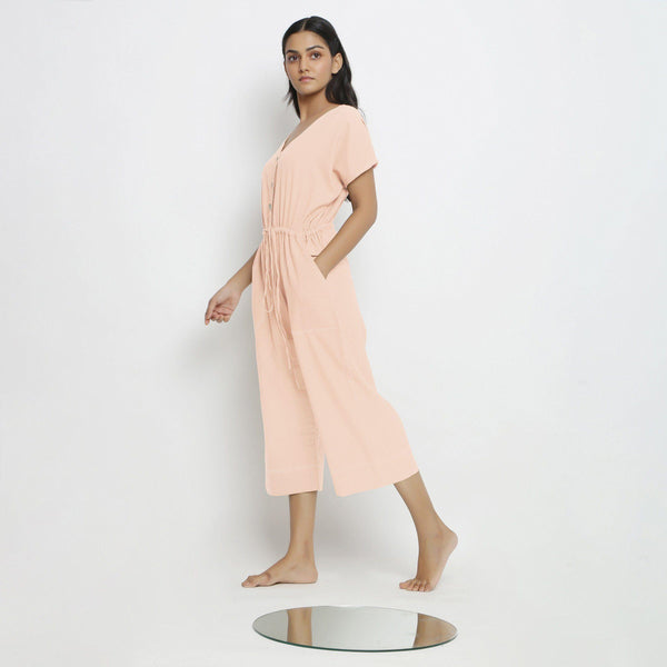 Left View of a Model wearing Powder Pink Vegetable Dyed Button-Down Jumpsuit
