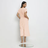 Back View of a Model wearing Powder Pink Vegetable Dyed Button-Down Jumpsuit