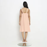 Back View of a Model wearing Powder Pink Vegetable Dyed Handspun Slip Dress