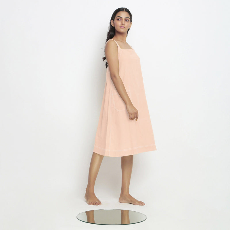 Right View of a Model wearing Powder Pink Vegetable Dyed Handspun Slip Dress