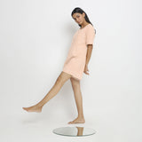 Left View of a Model wearing Powder Pink Vegetable Dyed Romper