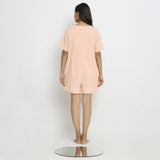 Back View of a Model wearing Powder Pink Vegetable Dyed Romper