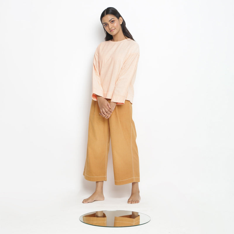 Front View of a Model wearing Powder Pink Vegetable Dyed Cotton Loose Fit Tie Neck Top