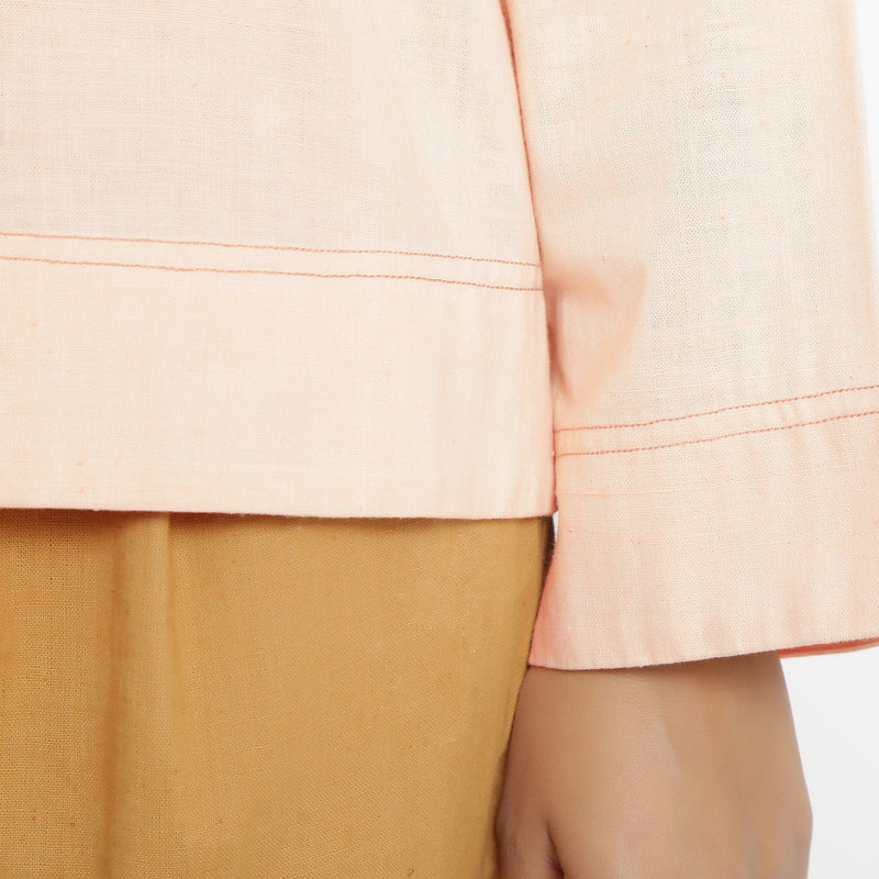 Close View of a Model wearing Powder Pink Vegetable Dyed Cotton Loose Fit Tie Neck Top