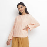 Front View of a Model wearing Powder Pink Vegetable Dyed Cotton Loose Fit Tie Neck Top