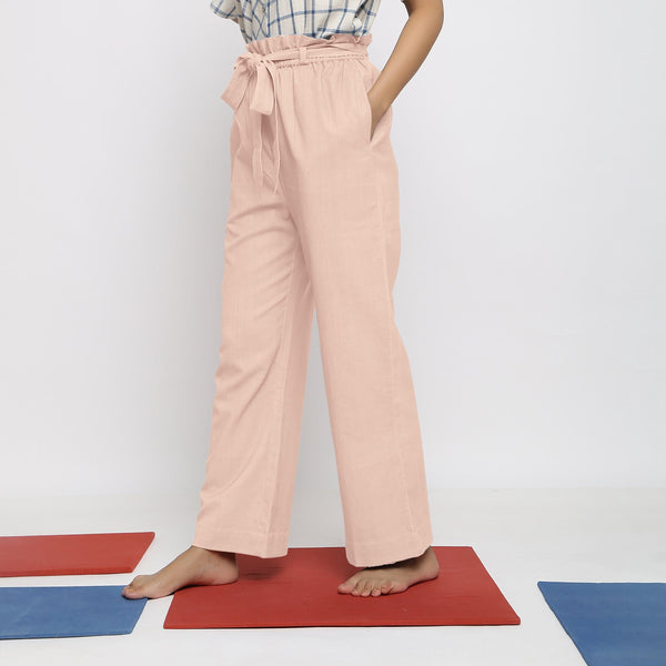 Left View of a Model wearing Powder Pink Vegetable Dyed Wide Legged Paperbag Pant