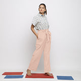 Right View of a Model wearing Powder Pink Vegetable Dyed Wide Legged Paperbag Pant
