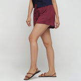 Left View of a Model wearing Red Yarn Dyed Mid Rise Flared Shorts