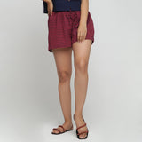 Front View of a Model wearing Red Yarn Dyed Mid Rise Flared Shorts