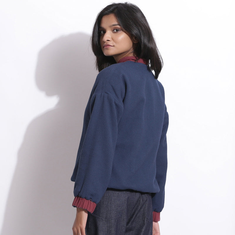 Back View of a Model wearing Reversible Blue Red Warm Cotton Waffle Bomber Jacket