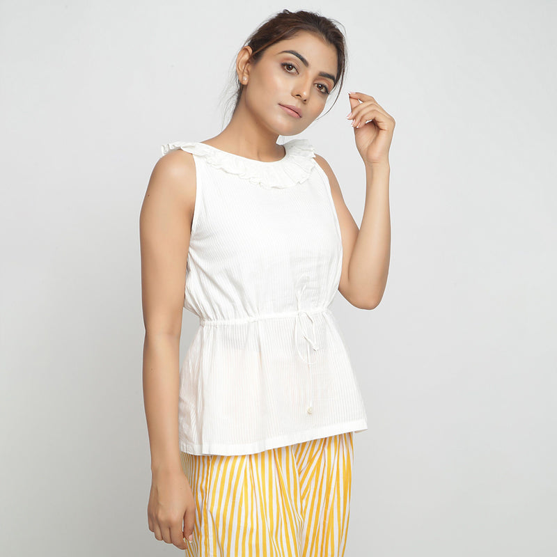 Right View of a Model wearing Ruffled Off-White Cotton Peplum Top