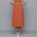 Back View of a Model wearing Sunset Rust Button-Down Midi Skirt