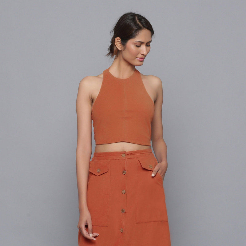 Front View of a Model wearing Sunset Rust Corduroy Halter Neck Top