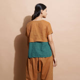 Back View of a Model wearing Rust Cotton Muslin Lined High-Low Top