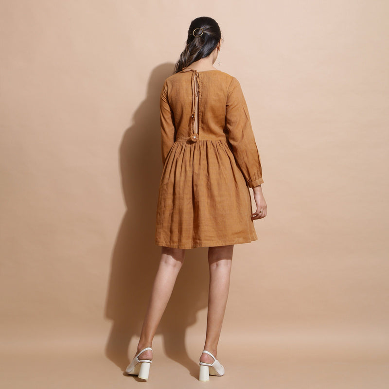 Back View of a Model wearing Rust Handspun Solid Gathered Dress