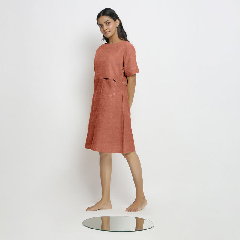 Left View of a Model wearing Rust 100% Linen Yoked Knee Length Shift Dress