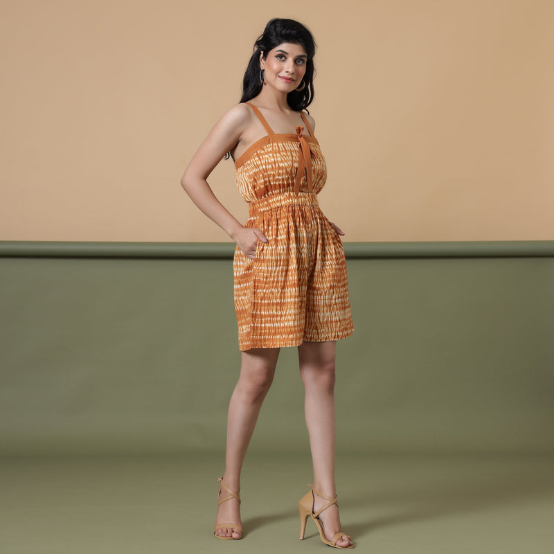 Right View of a Model wearing Rust Shibori Tie-Dye Cotton Strap Sleeve Gathered Romper