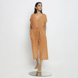 Front View of a Model wearing Rust Vegetable Dyed Button-Down Jumpsuit