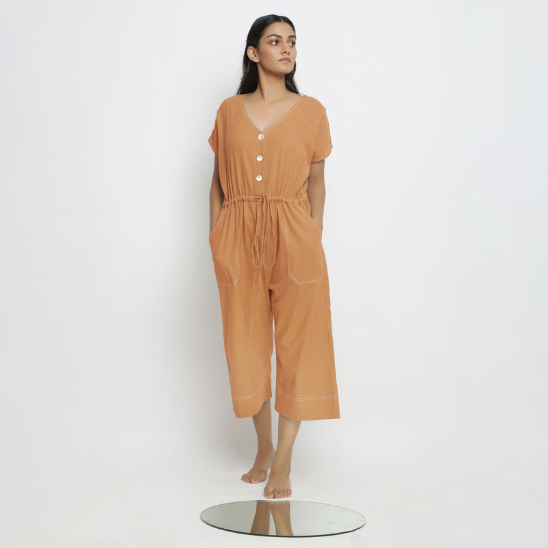Front View of a Model wearing Rust Vegetable Dyed Button-Down Jumpsuit