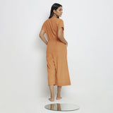 Back View of a Model wearing Rust Vegetable Dyed Button-Down Jumpsuit