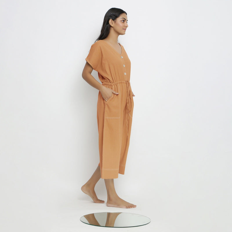 Right View of a Model wearing Rust Vegetable Dyed Button-Down Jumpsuit