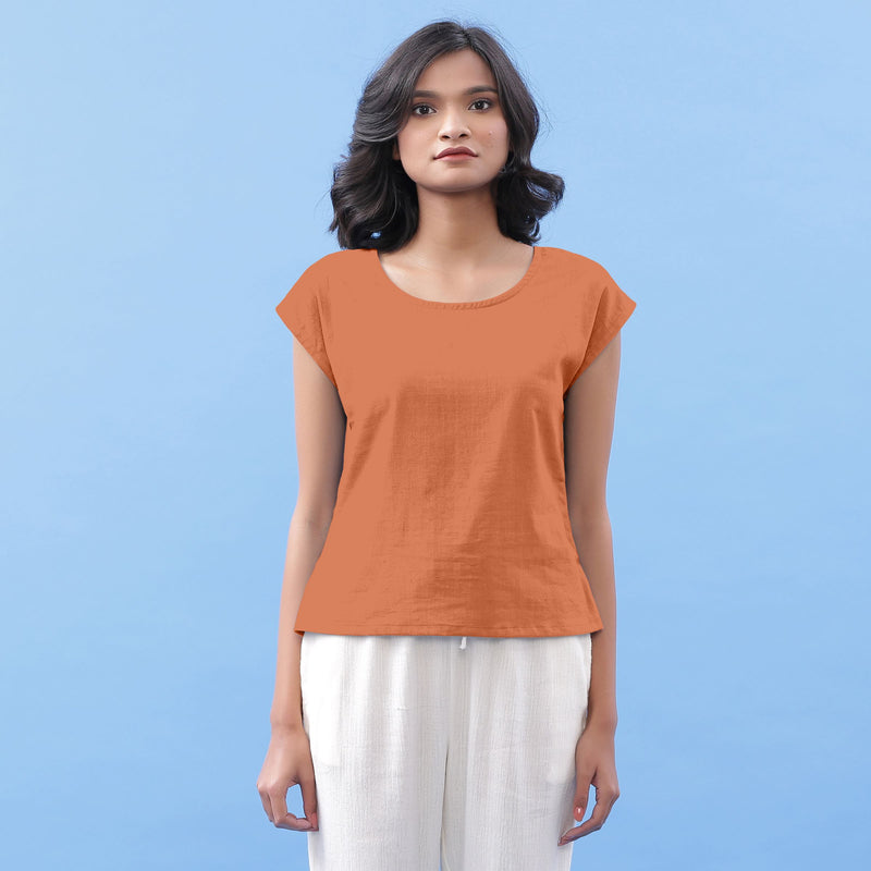 Front View of a Model wearing Rust Vegetable Dyed Handspun Cotton Essential Top