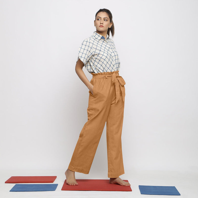 Right View of a Model wearing Rust Vegetable Dyed Wide Legged Paperbag Pant