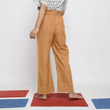 Back View of a Model wearing Rust Vegetable Dyed Wide Legged Paperbag Pant