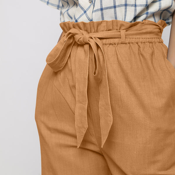 Front Detail of a Model wearing Rust Vegetable Dyed Wide Legged Paperbag Pant