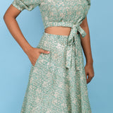 Front Detail of a Model wearing Sage Green Block Printed 100% Cotton High-Low Circular Skirt
