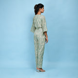 Back View of a Model wearing Sage Green Block Printed Ankle Length Cotton Jumpsuit