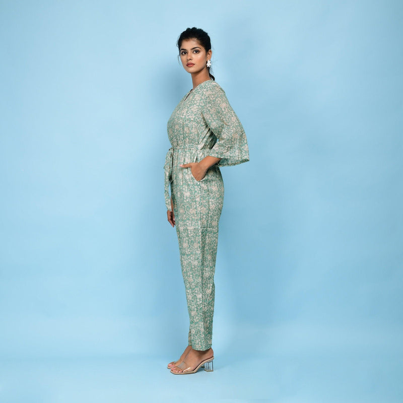 Left View of a Model wearing Sage Green Block Printed 100% Cotton Straight Jumpsuit