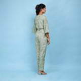 Back View of a Model wearing Sage Green Block Printed 100% Cotton Straight Jumpsuit
