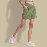 Right View of a Model wearing Sage Green Cotton Corduroy Baggy Shorts