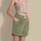Front Detail of a Model wearing Sage Green Cotton Corduroy Baggy Shorts