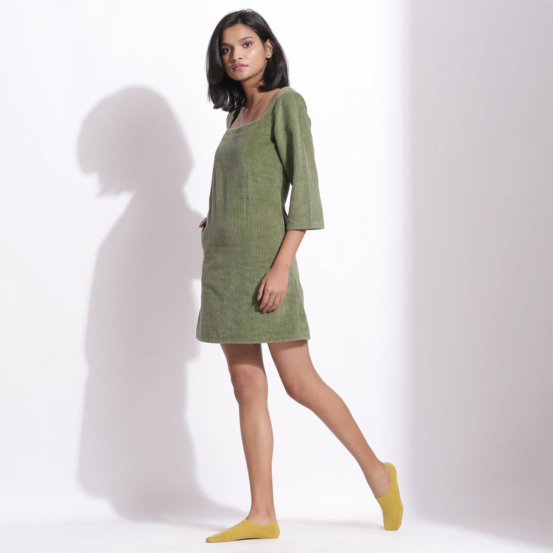 Left View of a Model wearing Sage Green Cotton Corduroy Square Neck Dress
