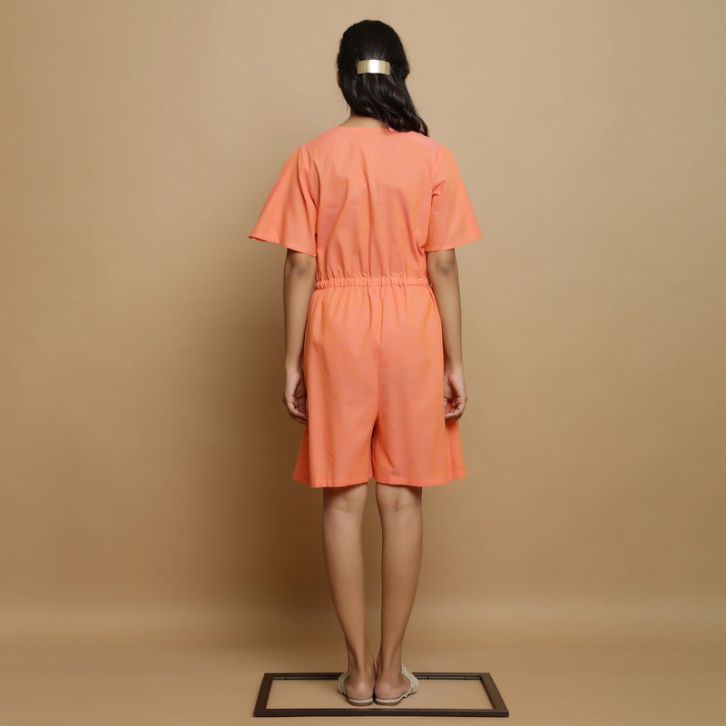Back View of a Model wearing Salmon Pink Button-Down Godet Jumpsuit
