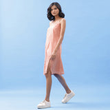 Left View of a Model wearing Salmon Pink Handspun Cotton Strap Slit Dress