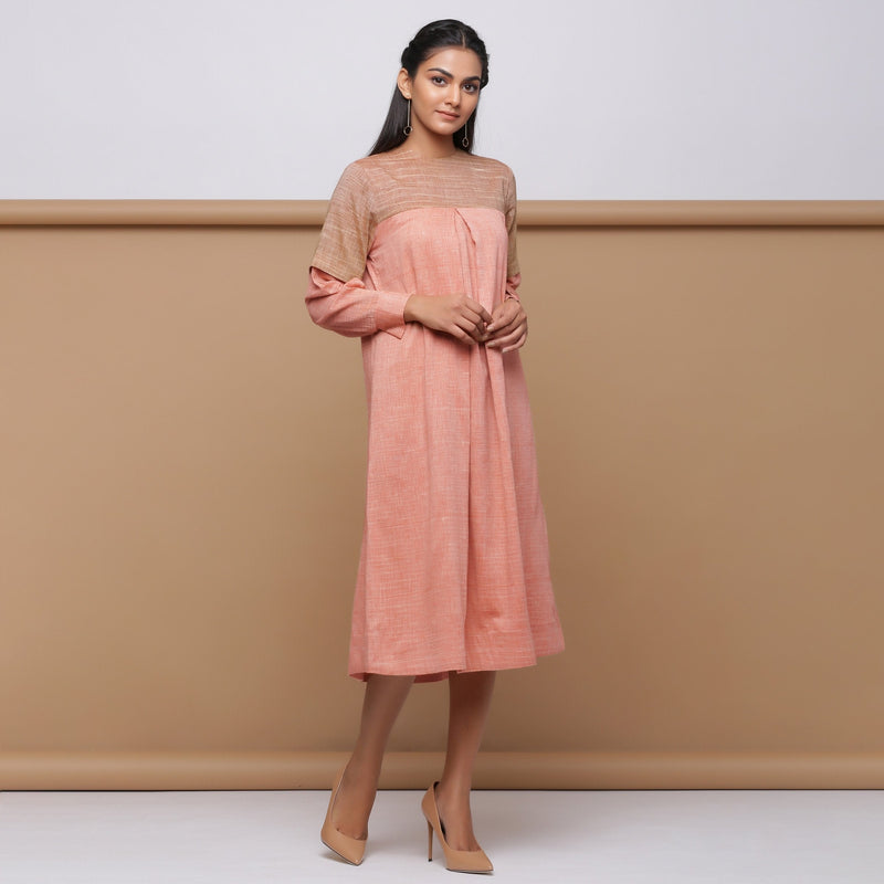 Right View of a Model wearing Salmon Pink Handspun Pleated Dress
