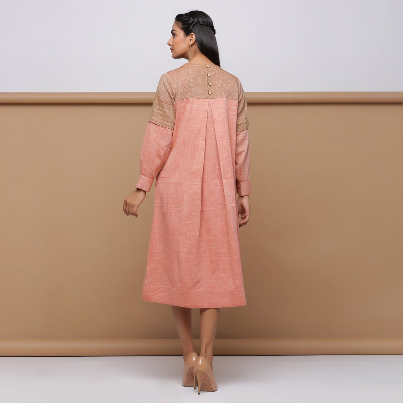 Back View of a Model wearing Salmon Pink Handspun Pleated Dress