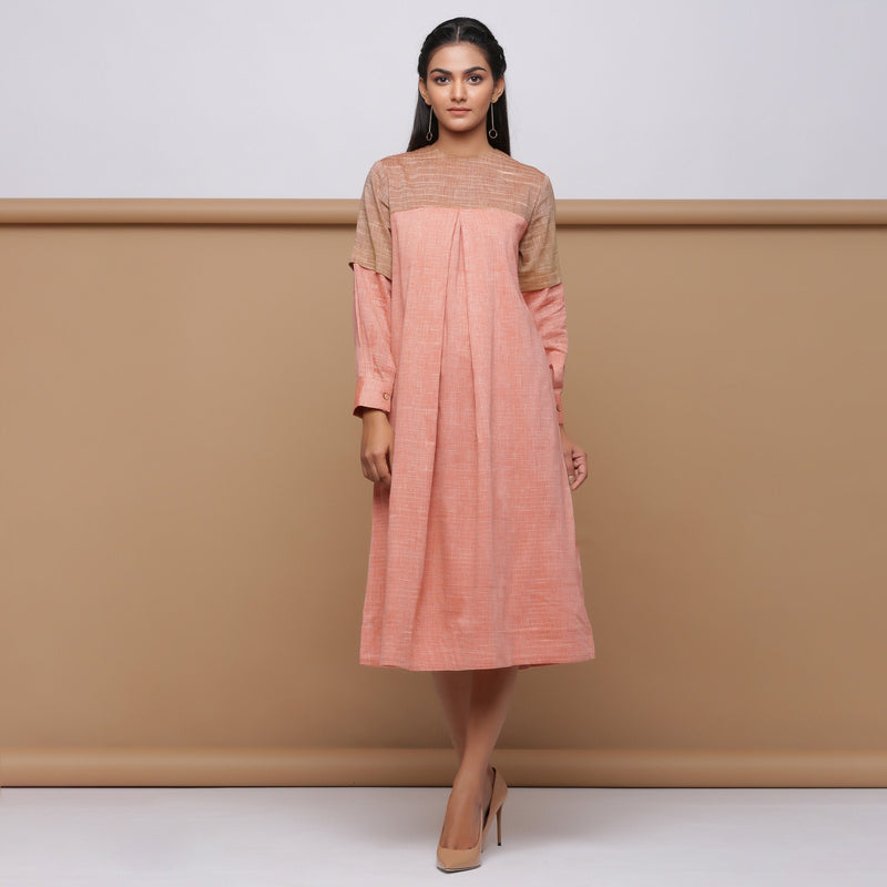 Front View of a Model wearing Salmon Pink Handspun Pleated Dress