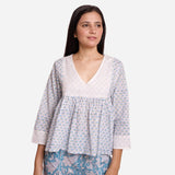 Front View of a Model wearing White Cotton Block Printed Floral V-Neck Top