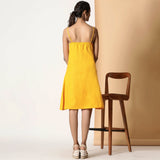 Back View of a Model wearing Sassy Yellow Cotton Flax Strappy Slit Dress