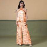 Front View of a Model wearing Shibori Flared Top and Sunset Orange Pant Set