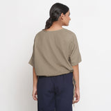 Back View of a Model wearing Solid Beige Cotton Flax Blouson Top