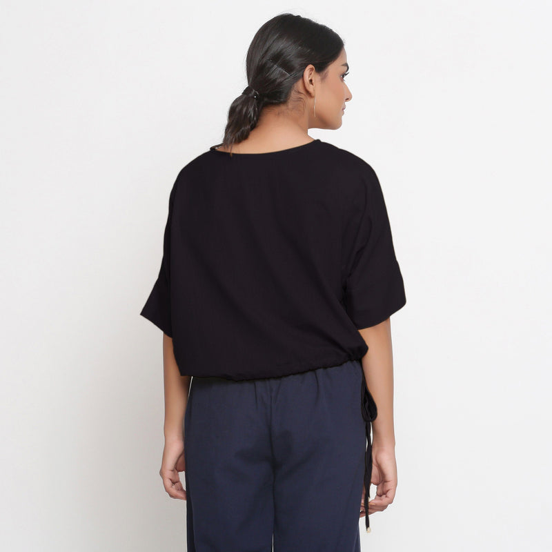 Back View of a Model wearing Solid Black Cotton Flax Blouson Top