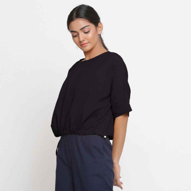 Left View of a Model wearing Solid Black Cotton Flax Blouson Top