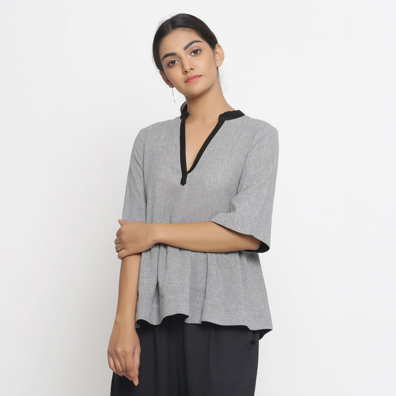 Front View of a Model wearing Solid Grey Yarn Dyed Cotton Peplum Top