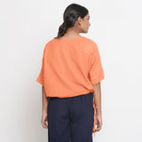 Back View of a Model wearing Solid Peach Cotton Flax Blouson Top