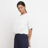 Left View of a Model wearing Solid White Cotton Flax Blouson Top
